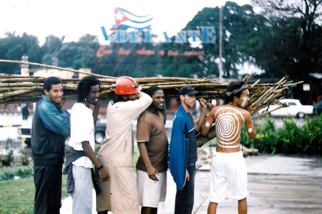 Amaury PAcheco y otras personas cargando un conjunto de ramas